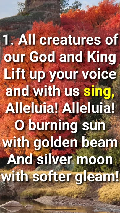 A hymn verse lighting up word by word over a photograph of autumn trees